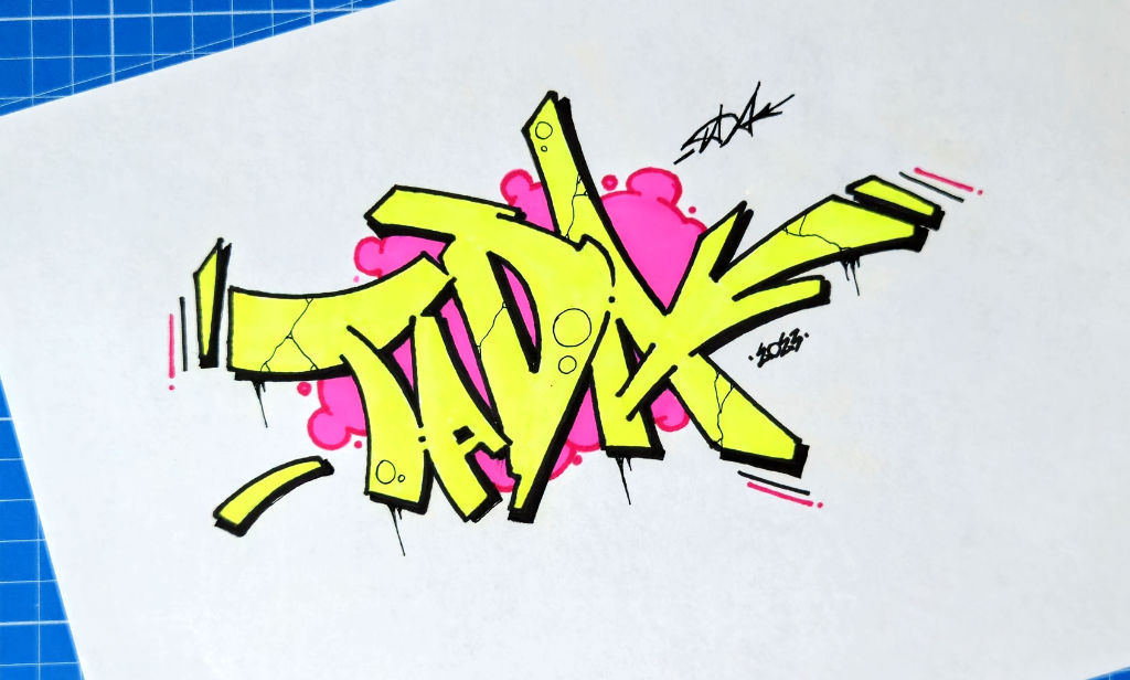 Photo of a Neon Yellow Tada Graffiti Drawing with pink bubbles as background